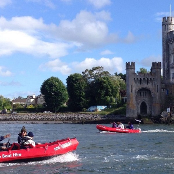 a group of people in a small boat in a body of water