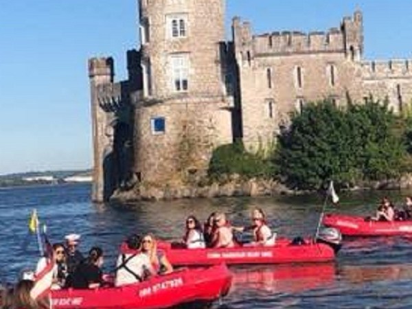 a group of people in a small boat in a body of water
