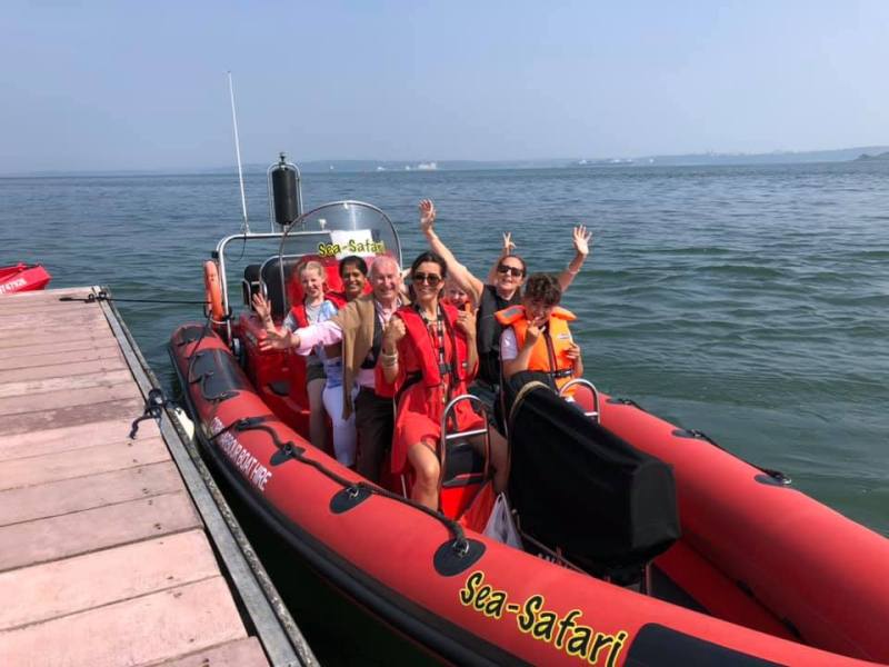 a group of people in a boat on a body of water