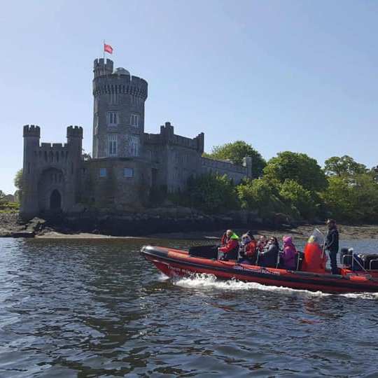 a group of people in a small boat in a body of water