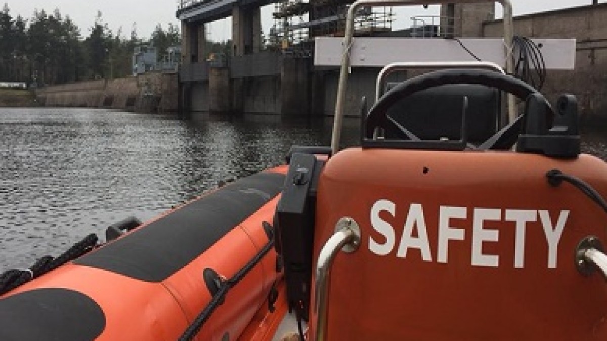 a train is parked on the side of a boat