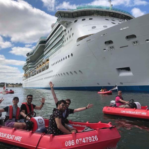 a group of people in a small boat in a large body of water