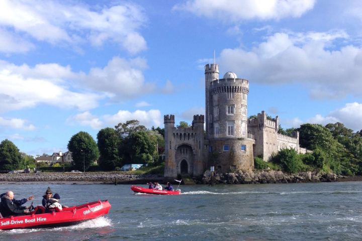 a group of people in a small boat in a body of water