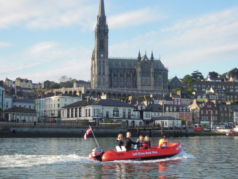 a group of people in a small boat in a large body of water