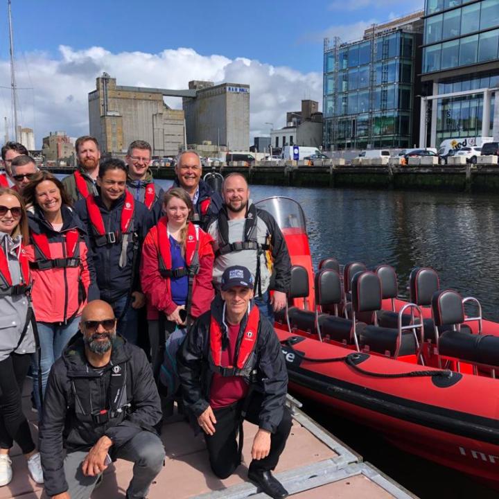 a group of people on a boat posing for the camera
